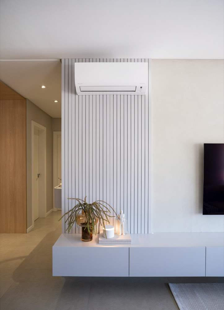 A wall-mounted indoor mini-split unit in a living room